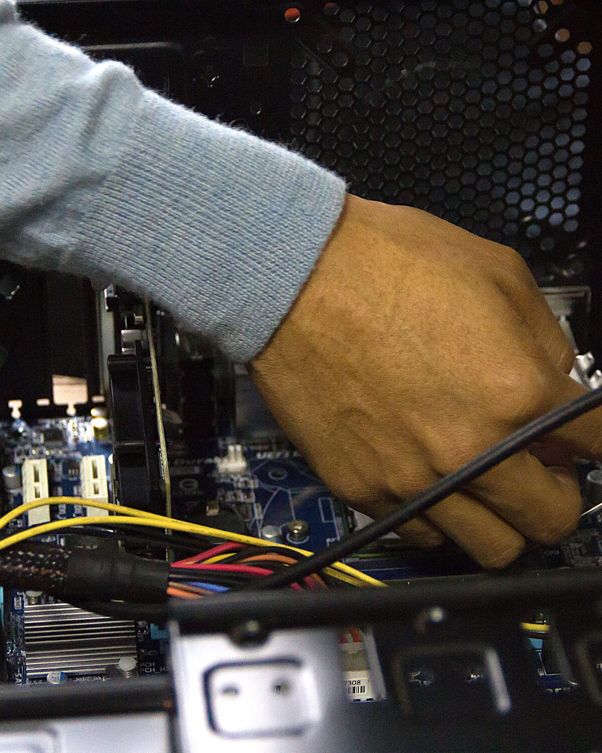 Technician performing a detailed internal computer repair